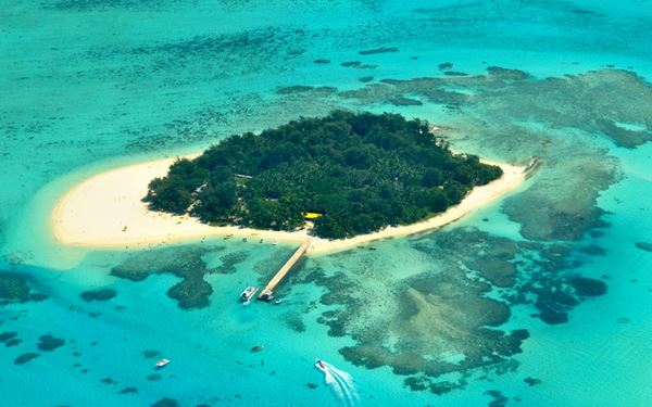 Managaha is a tiny, uninhabited islet located within the lagoon of Saipan, known for its pristine white-sand beaches and turquoise waters. It is a paradise for snorkeling and parasailing, offering some of the clearest water in the Pacific. The island is also a historic site, holding a monument for a legendary Carolinian chief, blending natural tropical beauty with local cultural significance.