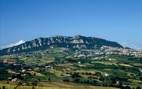 Mount Titano is the highest point in San Marino and a UNESCO World Heritage site, home to the three iconic towers. A scenic walking path, the "Passo delle Streghe" (Witches' Path), connects the towers along the ridge of the mountain. The dramatic limestone cliffs and the lush greenery provide a beautiful natural setting for the medieval history that defines this tiny, landlocked sovereign state.