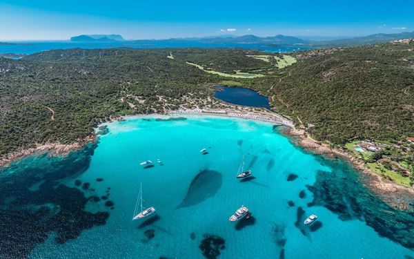 Costa Smeralda, or the "Emerald Coast," is famous for its crystal-clear turquoise waters and luxury resorts in Porto Cervo. This stretch of coastline is a playground for the global elite, featuring hidden coves and white-sand beaches like Spiaggia del Principe. It perfectly combines rugged natural beauty with high-end Mediterranean style, making it one of the most glamorous destinations in Italy.