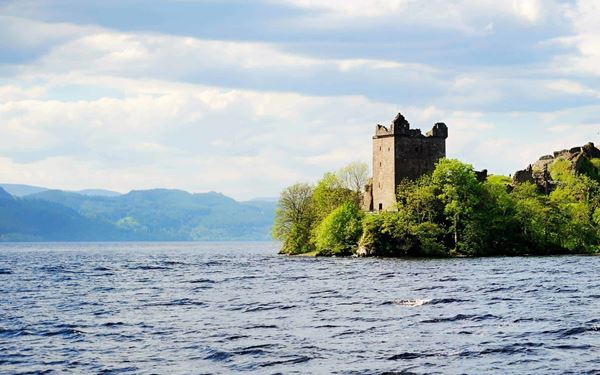 Loch Ness is a deep, freshwater loch in the Scottish Highlands, shrouded in the legend of the Loch Ness Monster, "Nessie." Visitors can explore the ruins of Urquhart Castle on its banks or take a boat tour to scan the dark waters. Surrounded by rolling hills and historic charm, it remains one of the most famous and mysterious bodies of water in the world.
