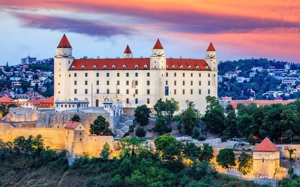 Bratislava Castle is a massive rectangular fortress with four corner towers, perched on a hill directly above the Danube River. It is the most prominent landmark of the capital city. The castle grounds offer panoramic views of Bratislava and neighboring Austria and Hungary. It houses a history museum and beautifully landscaped gardens, reflecting Slovakia’s rich royal and medieval past.