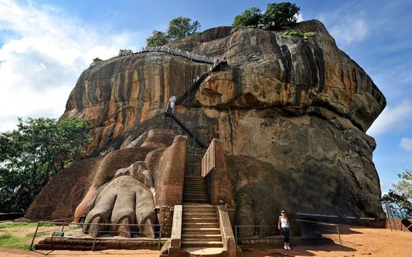 Sigiriya, or the "Lion Rock," is an ancient rock fortress and palace ruin located in the heart of Sri Lanka. This UNESCO site is famous for its stunning frescoes and the massive lion paws carved into the stone entrance. Climbing to the summit offers panoramic views of the surrounding jungle and ancient gardens, representing the incredible engineering of a bygone era.
