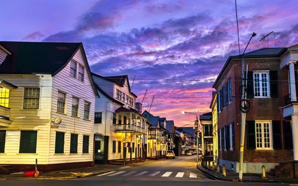 The Waterkant is the historic riverside street of Paramaribo and a UNESCO World Heritage site. It is lined with elegant white wooden colonial buildings and bustling markets. As the sun sets, the area becomes a vibrant social hub with food stalls and outdoor cafes. It perfectly captures the multicultural soul of Suriname, reflecting its Dutch heritage and its lively, tropical atmosphere along the Suriname River.