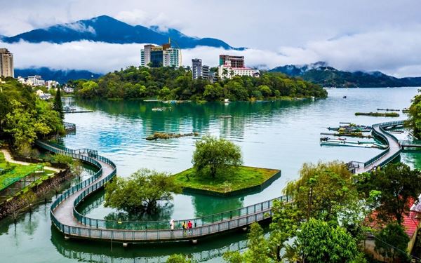 Sun Moon Lake is Taiwan's largest alpine lake, known for its serene turquoise waters and mountainous backdrop. The lake is divided by a small island, with one side resembling the sun and the other a crescent moon. It is a popular spot for cycling, boat tours, and visiting the nearby Wenwu Temple, offering a peaceful and scenic escape in the heart of the island.