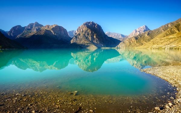 Iskanderkul is a stunning turquoise mountain lake located in the Fann Mountains, named after Alexander the Great. Surrounded by jagged peaks, it is often called the "Pearl of the Pamirs." Visitors can hike to a nearby 40-meter waterfall or visit the "Snake Lake." Its serene beauty and the legends surrounding its name make it one of Tajikistan’s most popular and legendary natural landmarks for hikers and nature lovers.