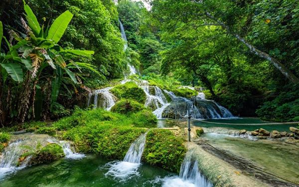 Located near Port Vila, the Mele Cascades are a series of beautiful terraced waterfalls that flow into clear turquoise pools. Visitors can hike through the lush jungle and even climb up the limestone falls using guide ropes. The top offers a refreshing swimming spot and panoramic views of Mele Bay. It is a popular and stunning natural landmark that showcases the tropical island beauty and green landscapes of Efate.