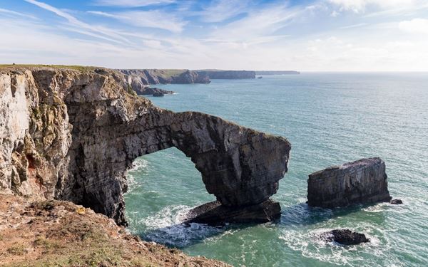 The Pembrokeshire Coast is the only national park in the UK focused primarily on its coastline. It features spectacular cliffs, hidden sandy beaches like Barafundle Bay, and the historic St. Davids Cathedral. The coast path offers world-class hiking and opportunities to see puffins and Atlantic grey seals. It is a stunning display of natural coastal beauty, blending rugged maritime landscapes with a rich, peaceful spiritual heritage.