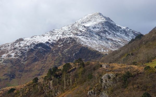 Snowdonia is a spectacular national park dominated by Snowdon, the highest mountain in Wales and England. It features jagged peaks, deep valleys, and over 100 lakes. Visitors can hike the rugged trails or take the historic mountain railway to the summit for breathtaking views of the Irish Sea. It is a premier destination for outdoor adventure, reflecting the wild, ancient, and majestic landscape of the Welsh heartland.